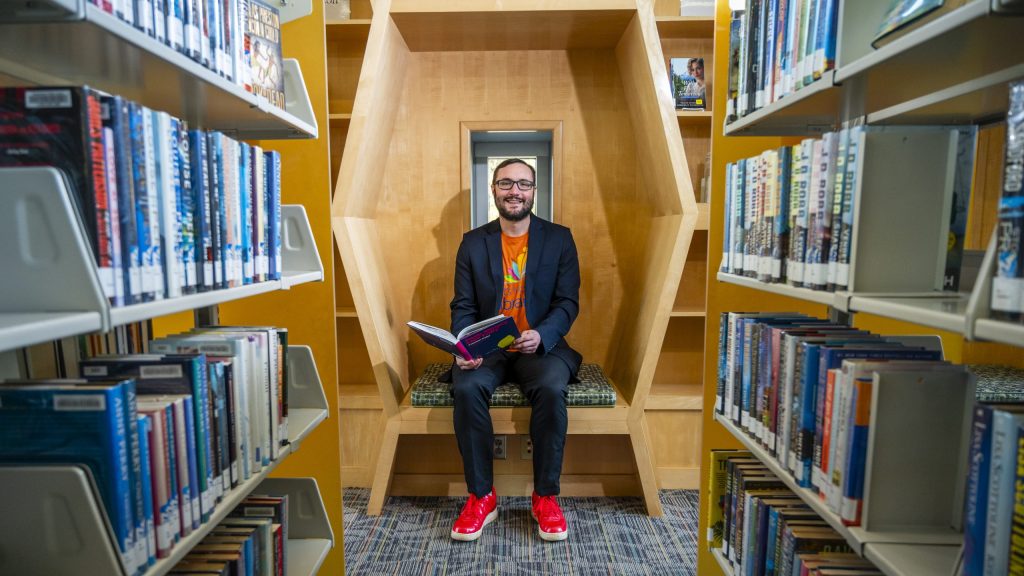 Lenstra sits in a library with a open book