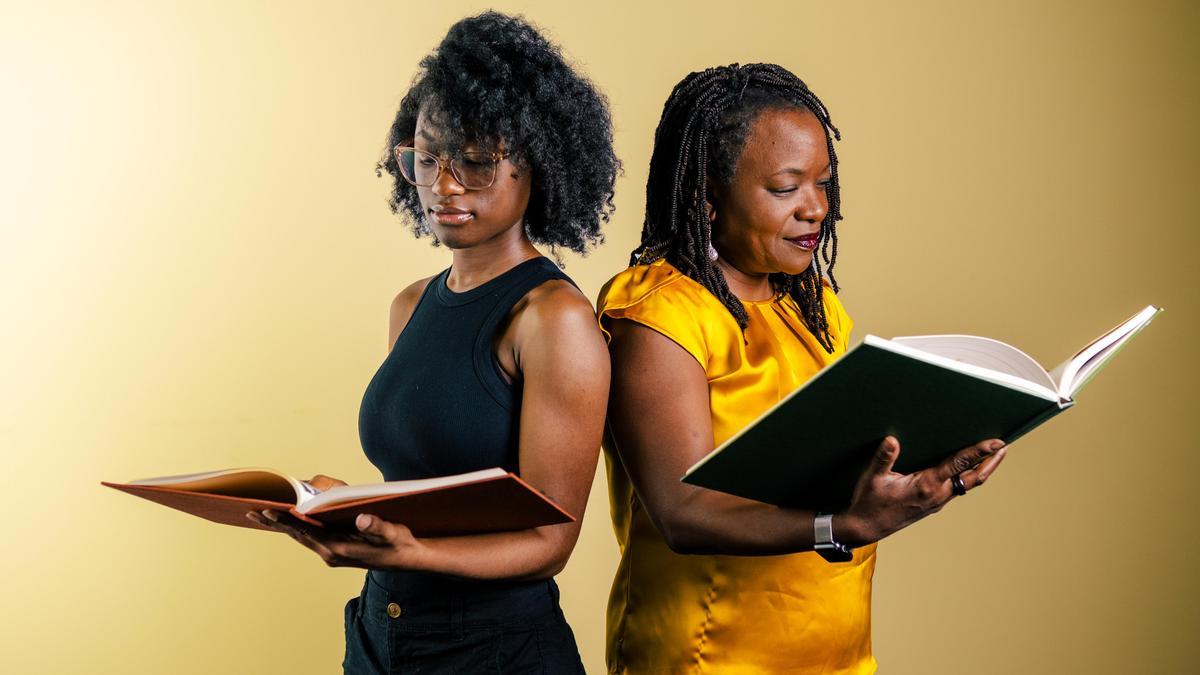 Associate Vice Provost Regina McCoy reads with an undergraduate student